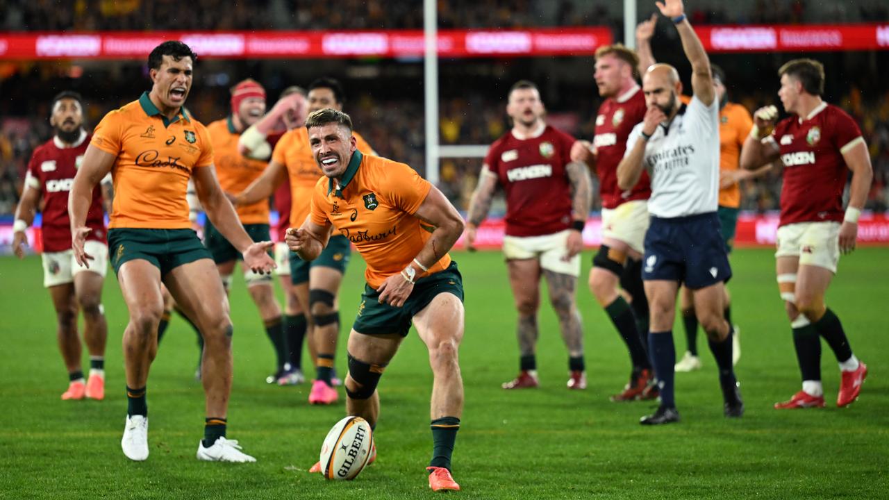 Jake Gordon of Australia reacts after scoring a try .