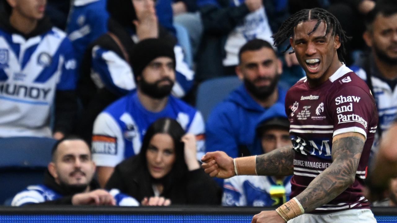 Jason Saab of the Sea Eagles celebrates after scoring a try.