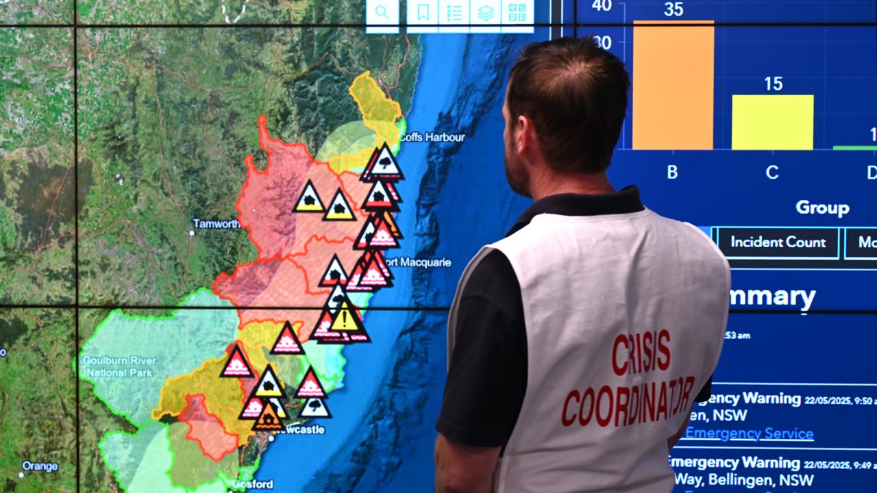 A Crisis Coordinator looks at a map of flood affected areas in NSW