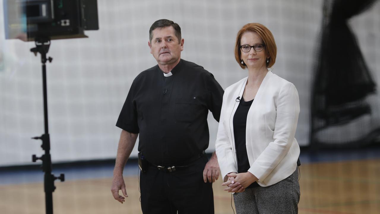 A file photo of Father Chris Riley and Julie Gillard