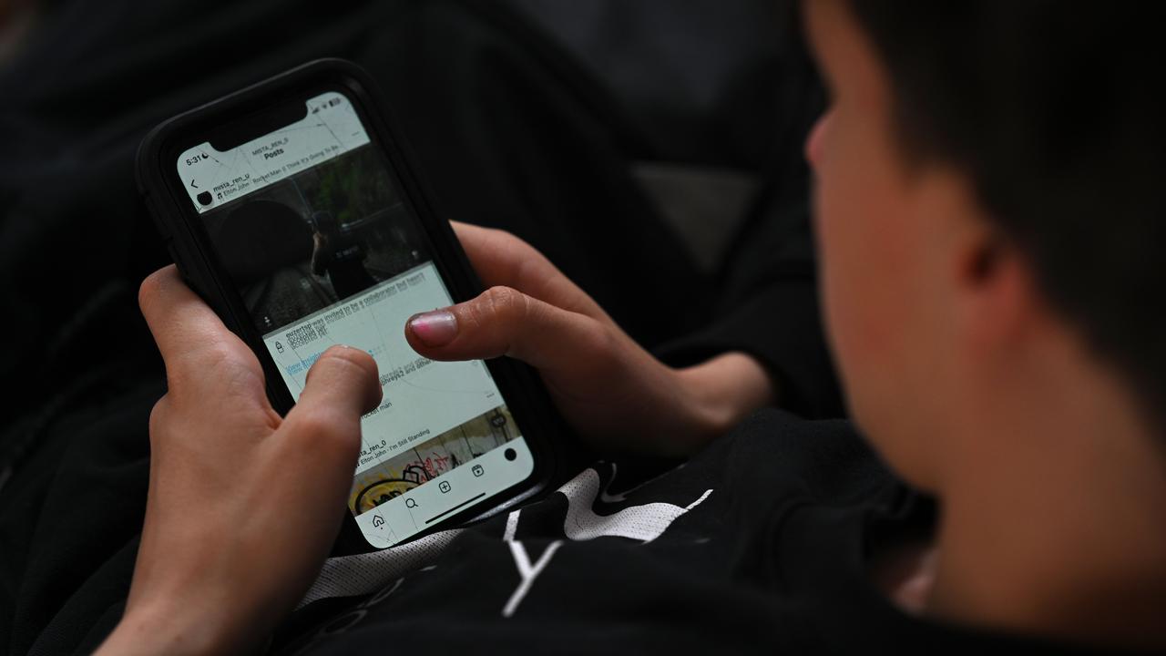 teenager uses his mobile phone