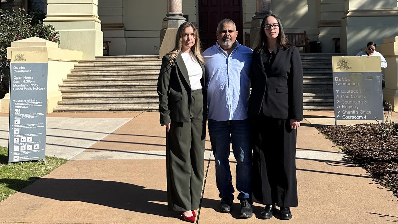 ALS solicitors Emma Parker and Tia Caldwell with Michael Brown