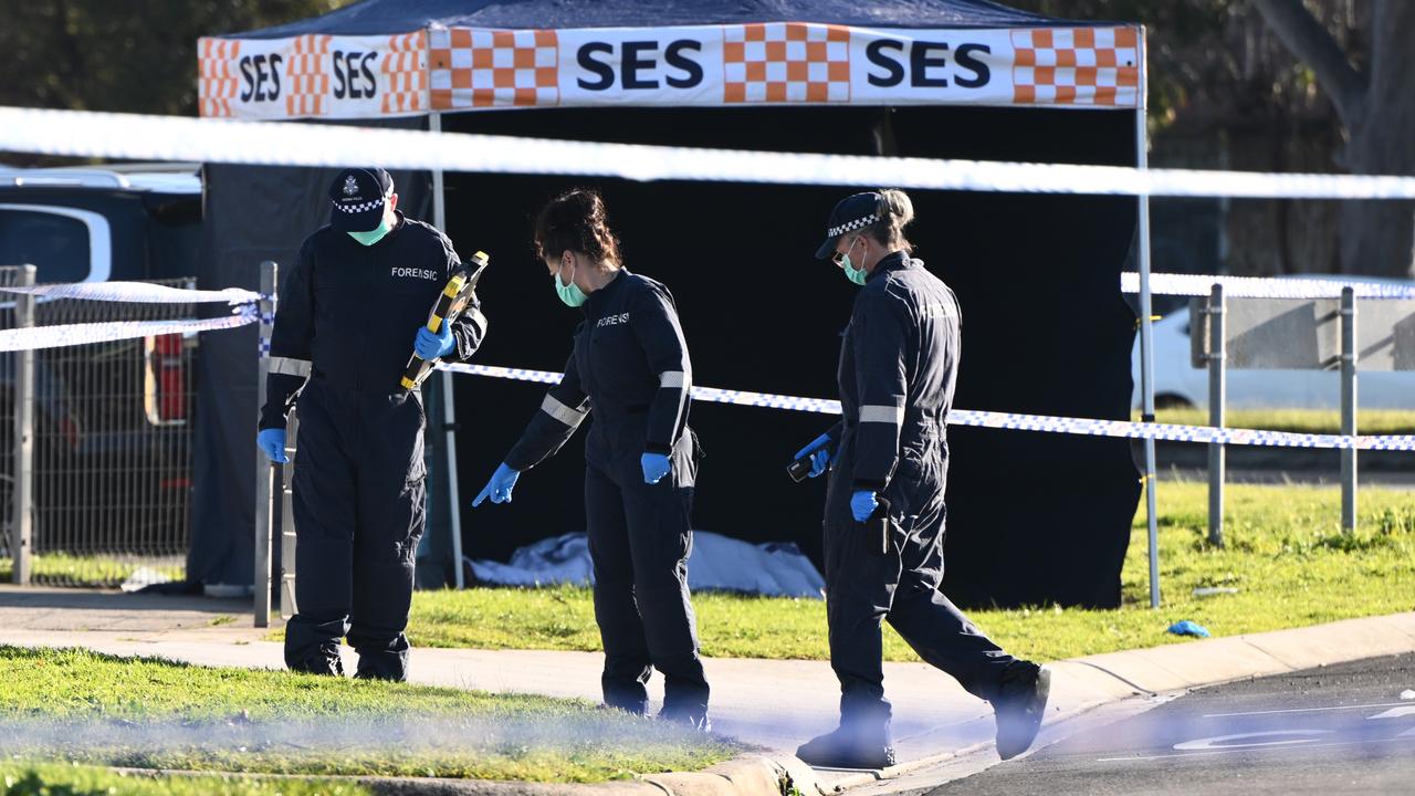 Police at the scene of a fatal stabbing near a BP service station