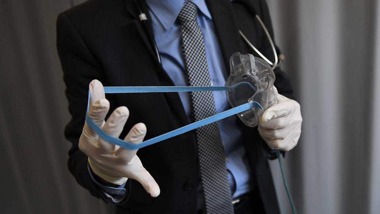 A medical doctor is seen holding an asthma ventilator mask