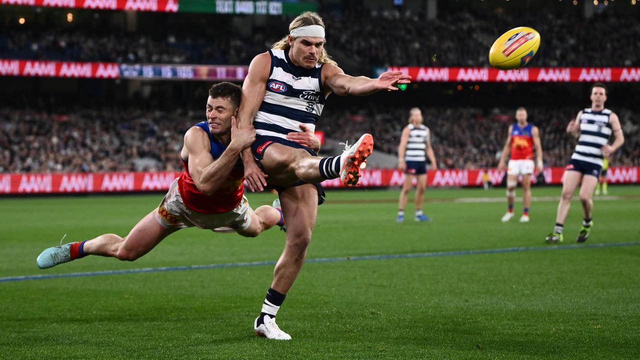 Josh Dunkley of the Lions tackles Bailey Smith of Geelong