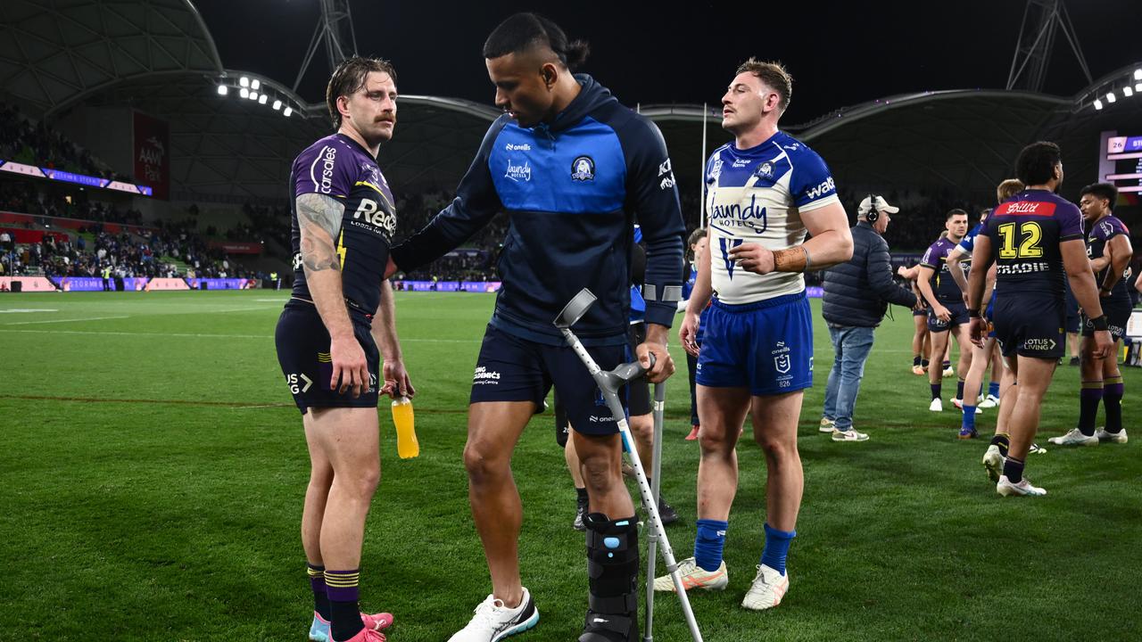 Cameron Munster chats with injured Bulldog Stephen Crichton.