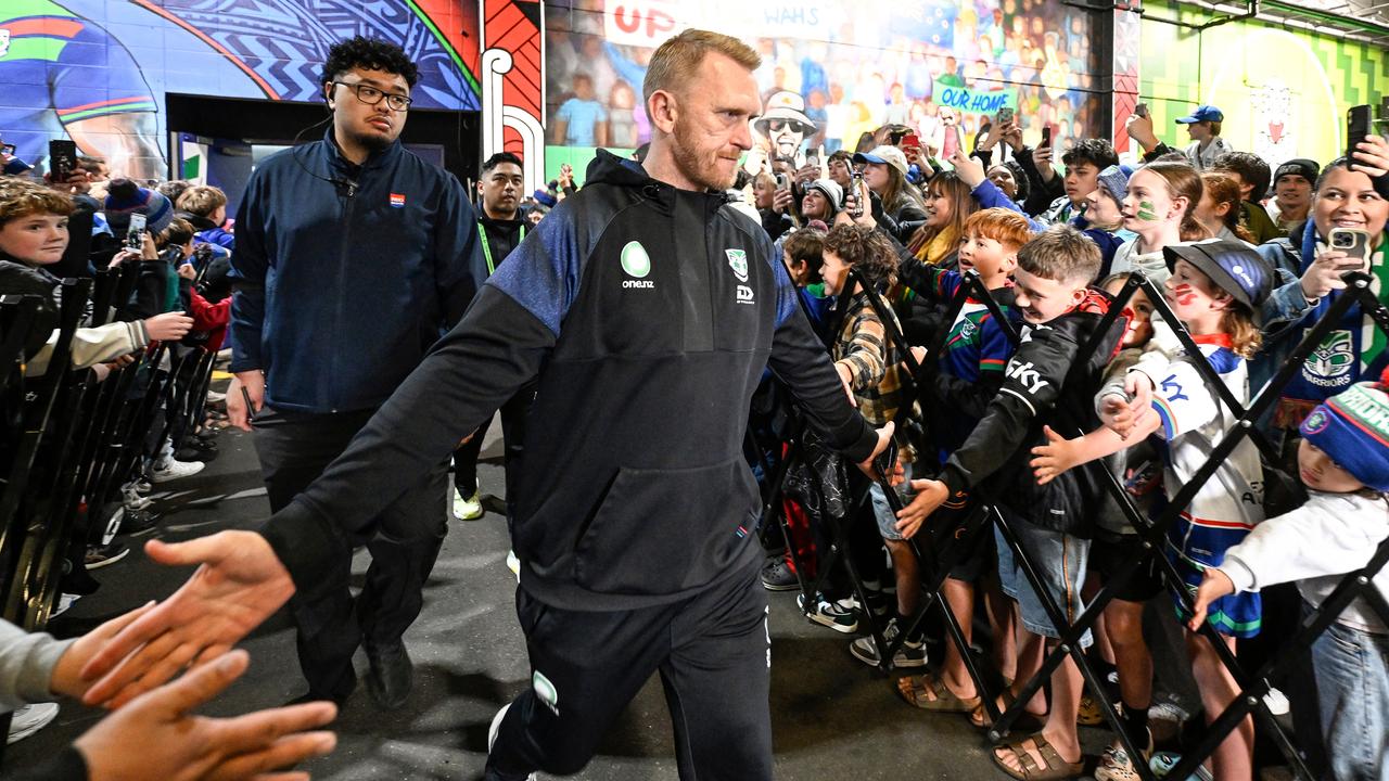 Warriors coach Andrew Webster greets fans.
