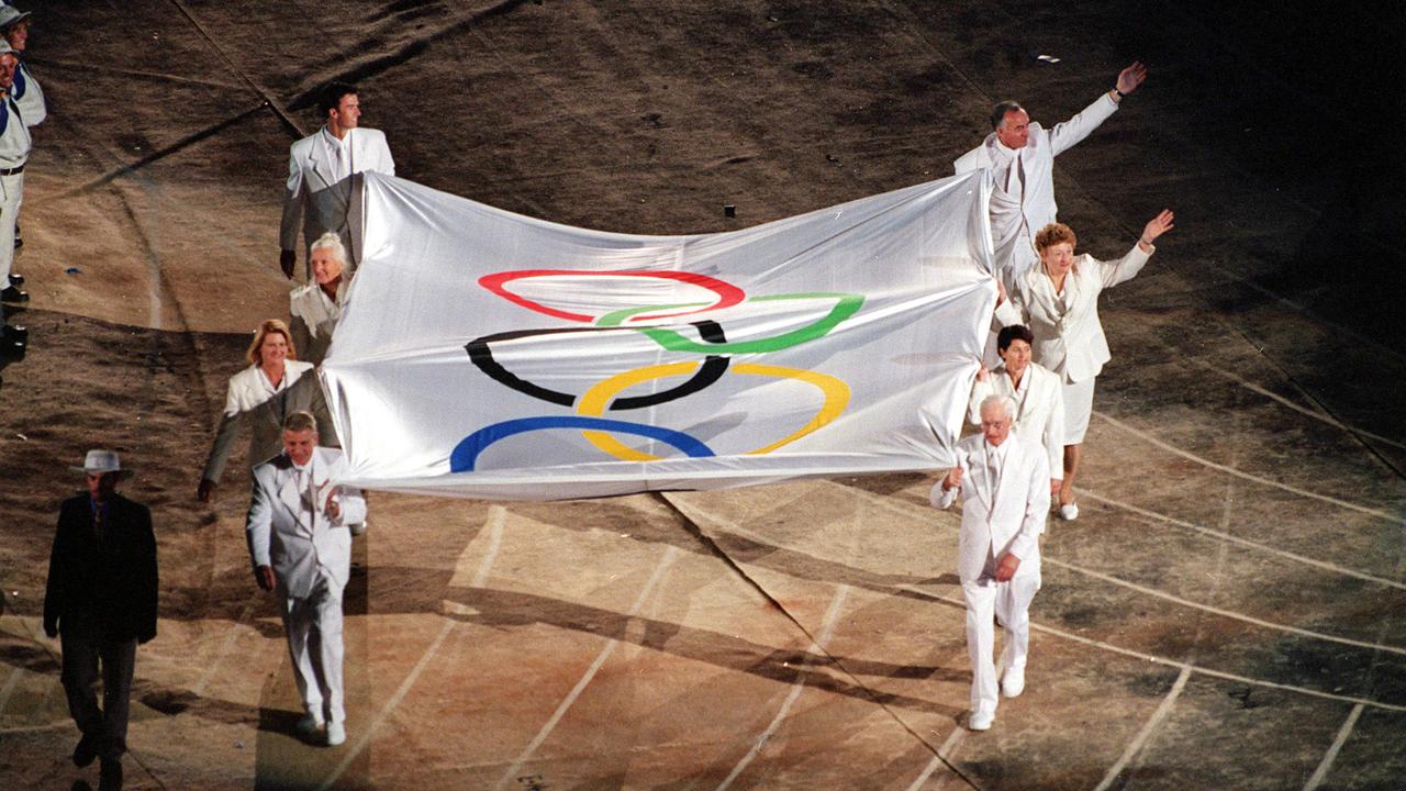 The Olympic flag is carried into Sydney's Stadium Australia.