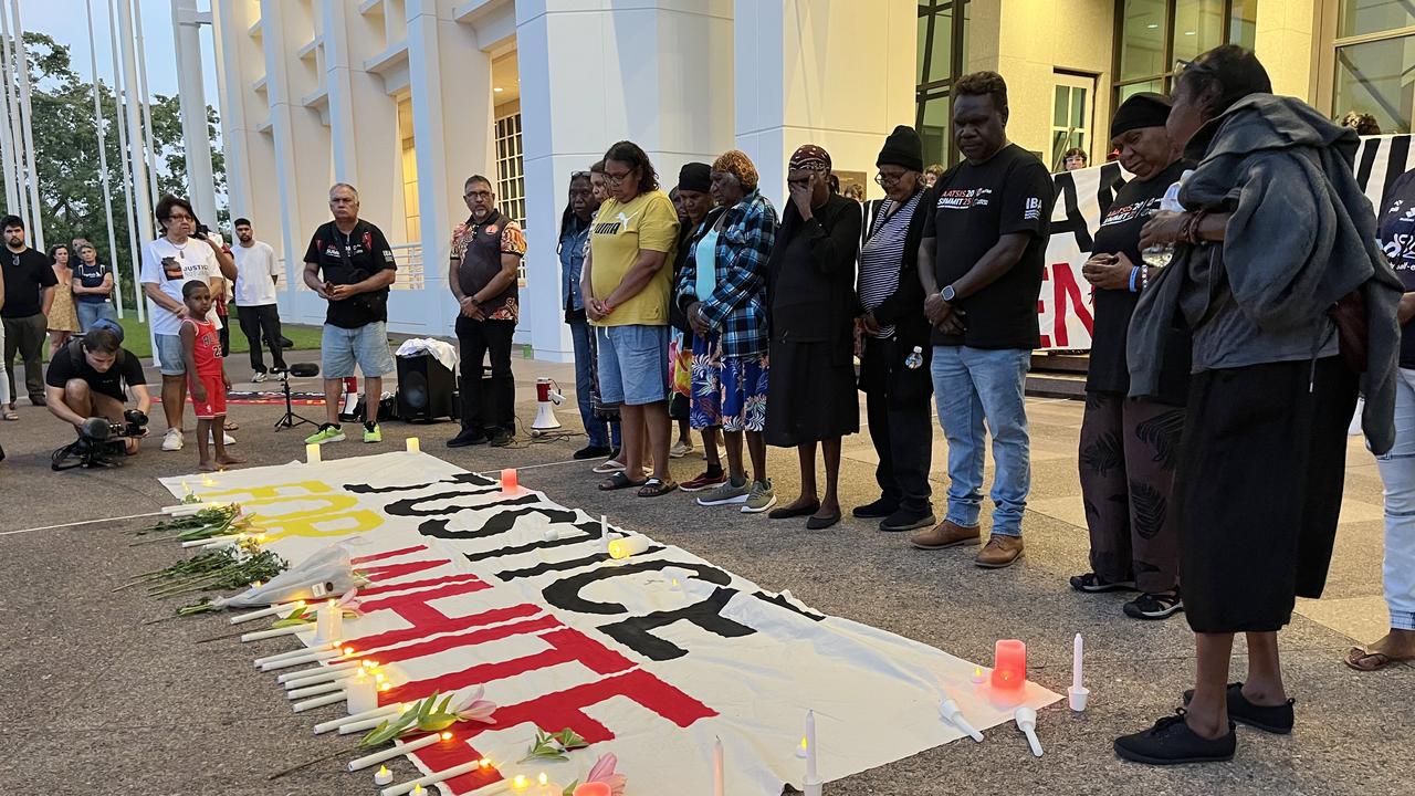 Mourners at a candle-lit vigil indigenous man Kumanjayi White