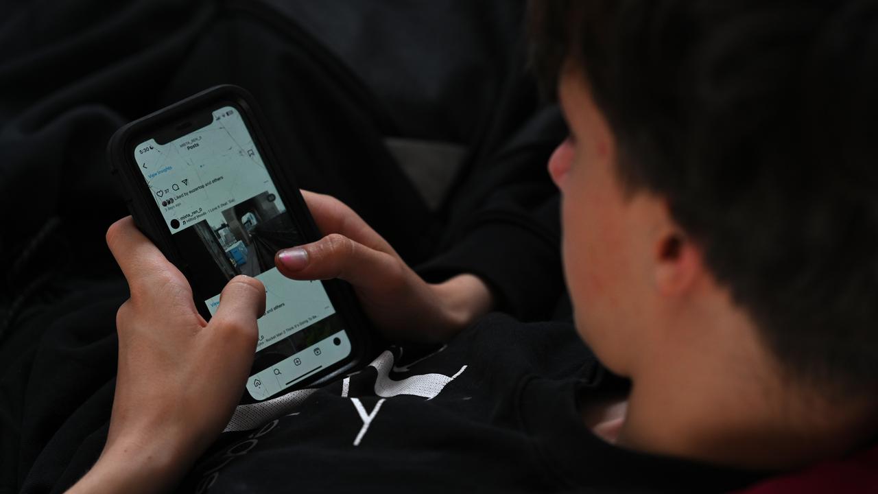 A teenager uses a phone to access social media (file image)
