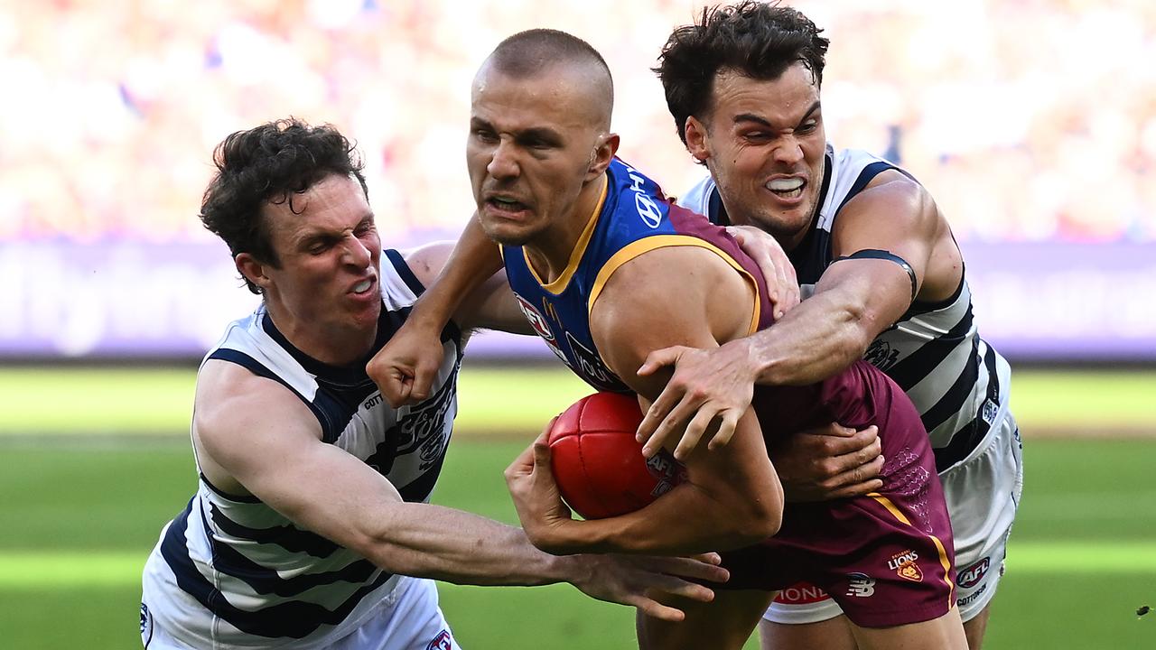 Max Holmes of Geelong (left) tackles Kai Lohmann