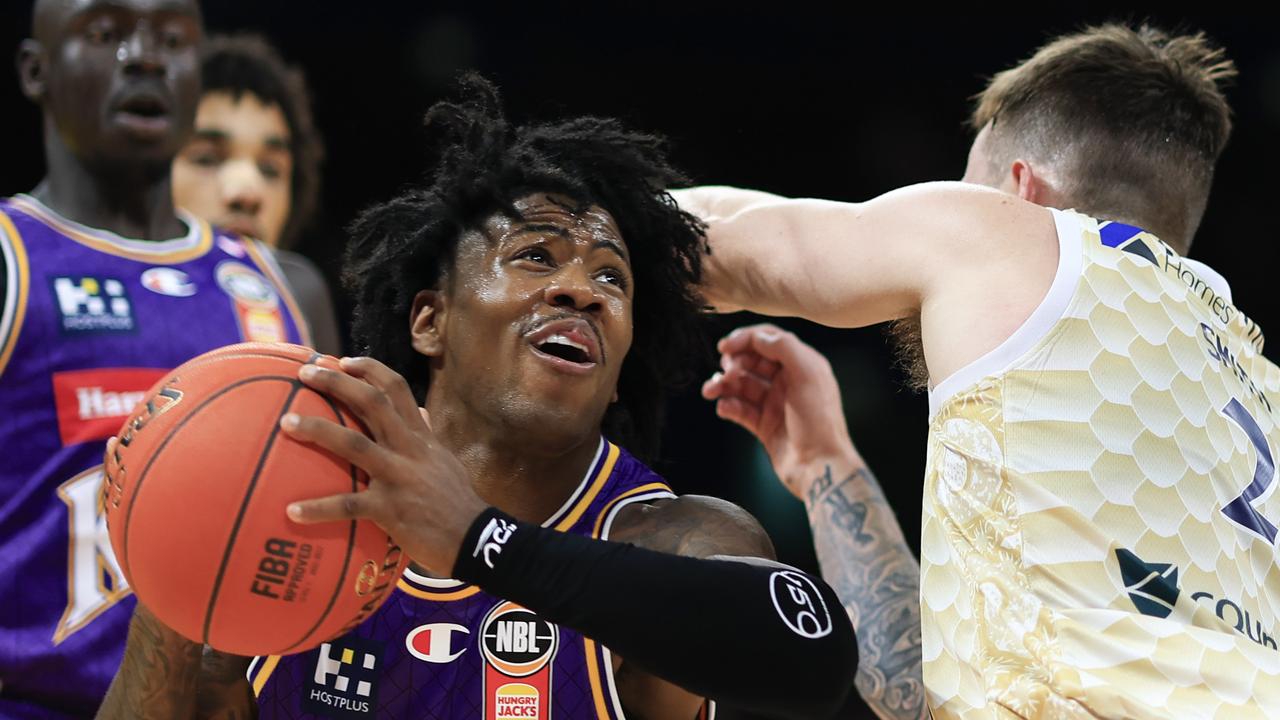 Kendric Davis looks for a way around the Taipans' Reyne Smith.