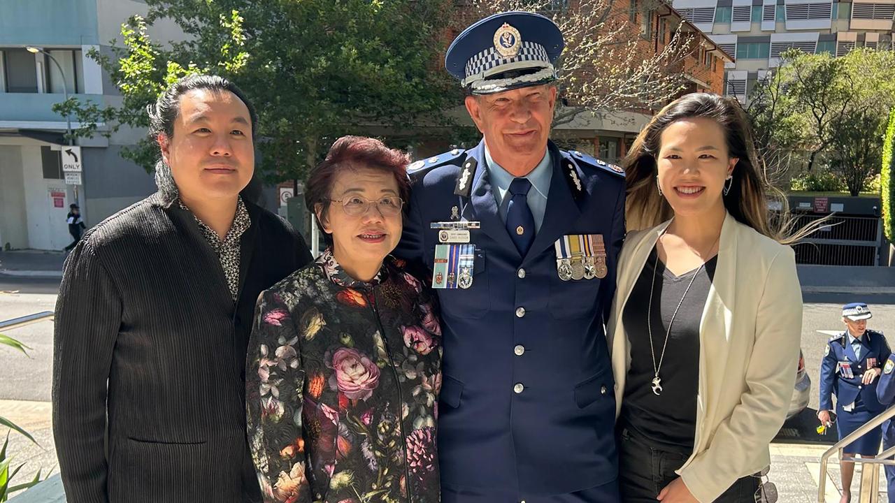 Deputy Commissioner David Hudson and the family of Curtis Cheng