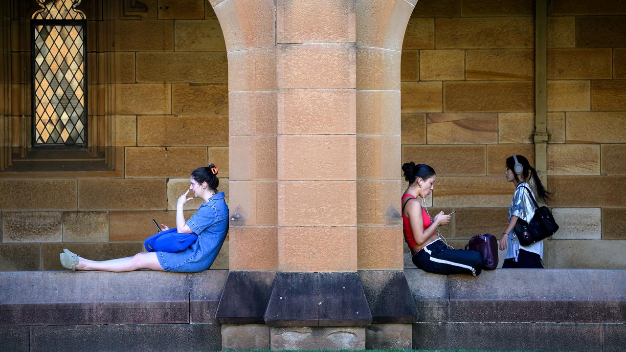 Students are seen on their phones at a university