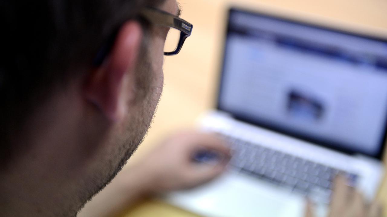 Man uses a laptop computer in Brisbane