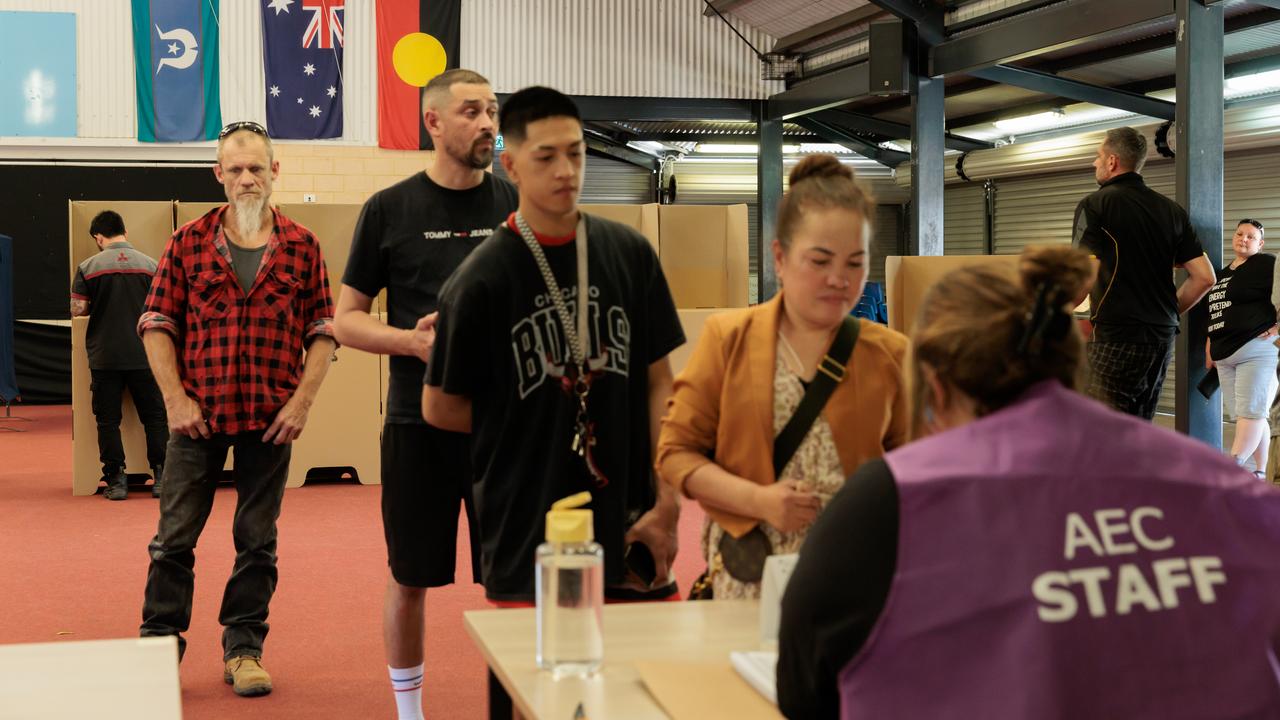 People at a voting booth for the Voice referendum.