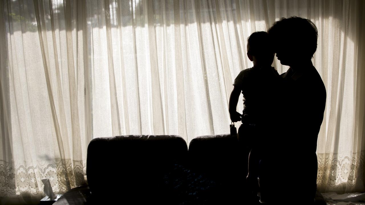 A woman and chid in the shadows