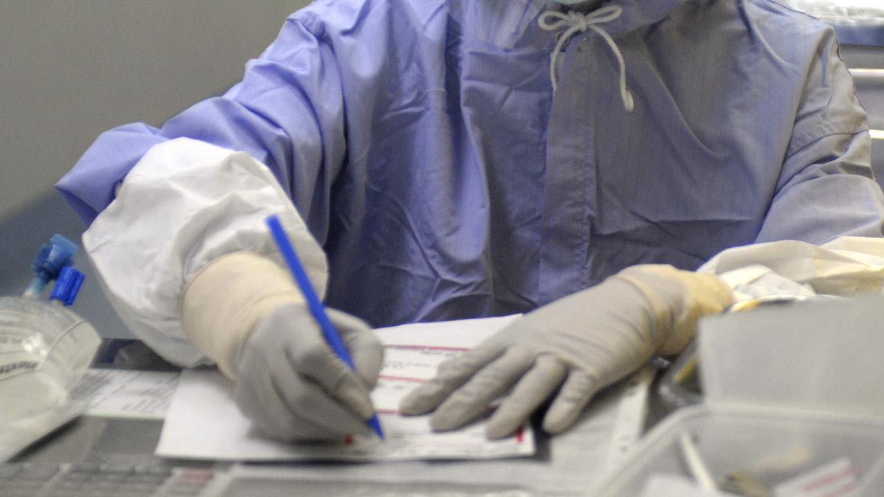 A lab technician wearing PPE (file image)