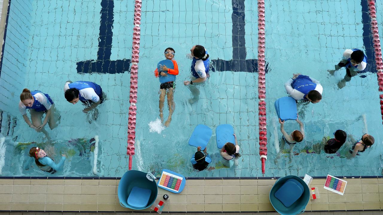 Kids participate in swimming lessons