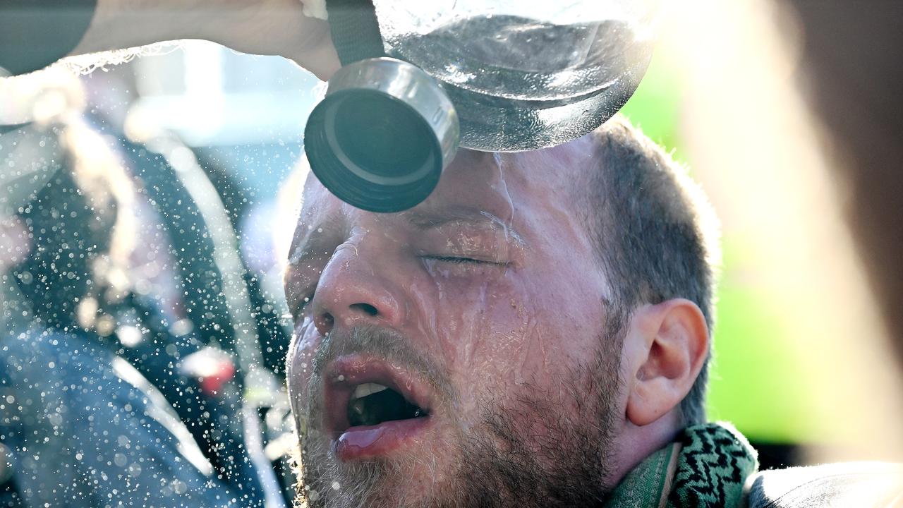 A protester washes his eyes after being pepper sprayed  by NSW Police 