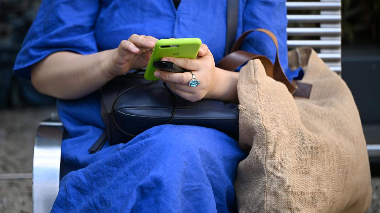 A woman seen using a smartphone device in Melbourne