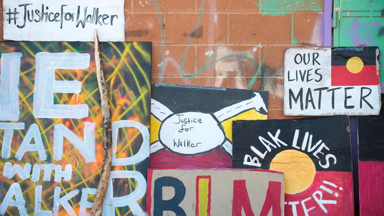 Protest signs are seen in the outback community of Yuendumu, NT
