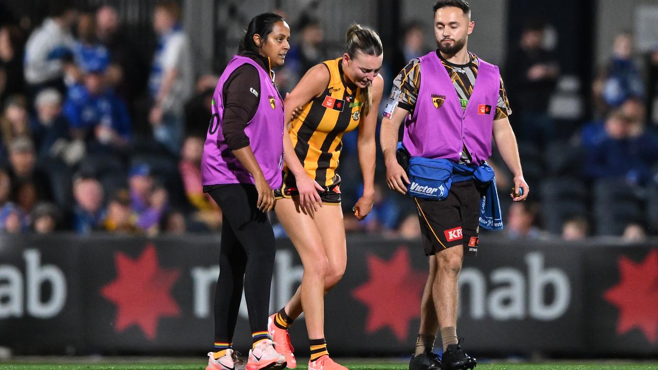 Hawthorn's Aine McDonagh is helped from the field.