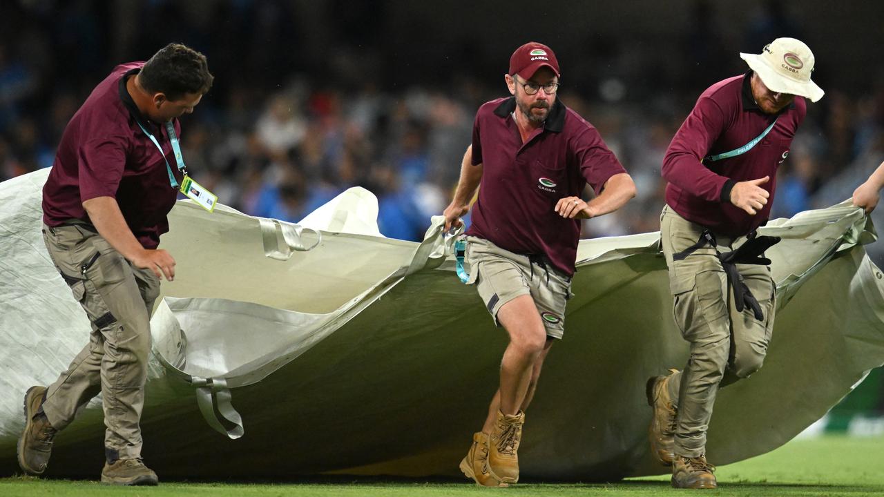 Gabba ground staff with covers.