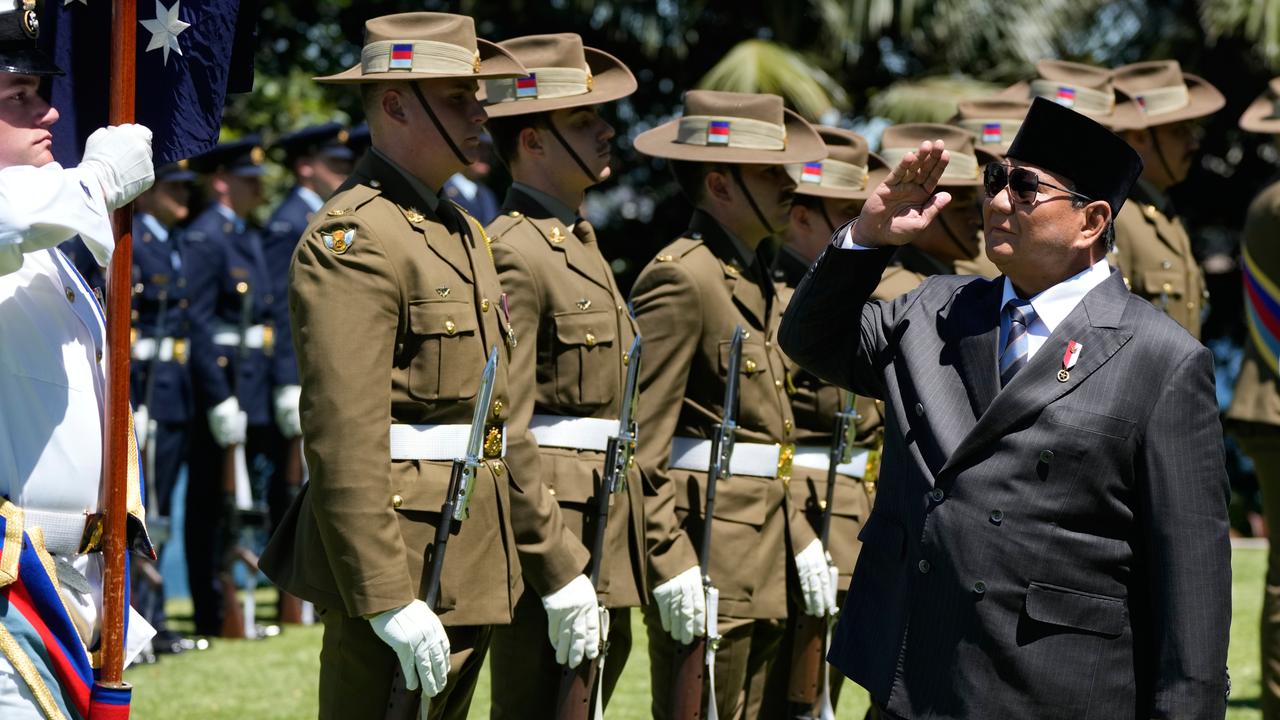 The Indonesian President with soldiers at a welcome ceremony