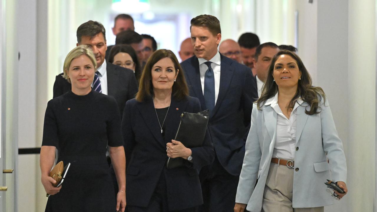 Liberal MPs and senators leave a party room meeting in Canberra