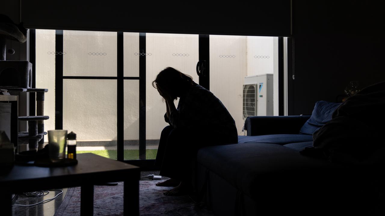 A woman with her hands over her face