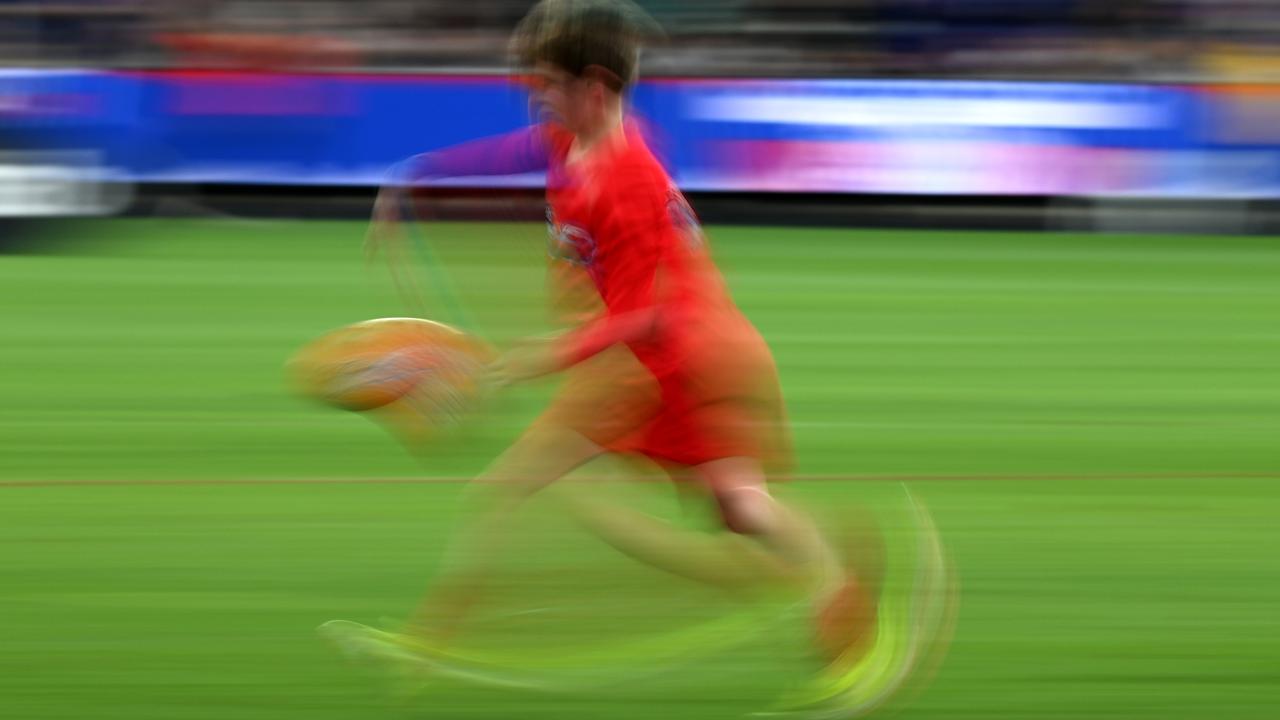Stock image of kid playing football