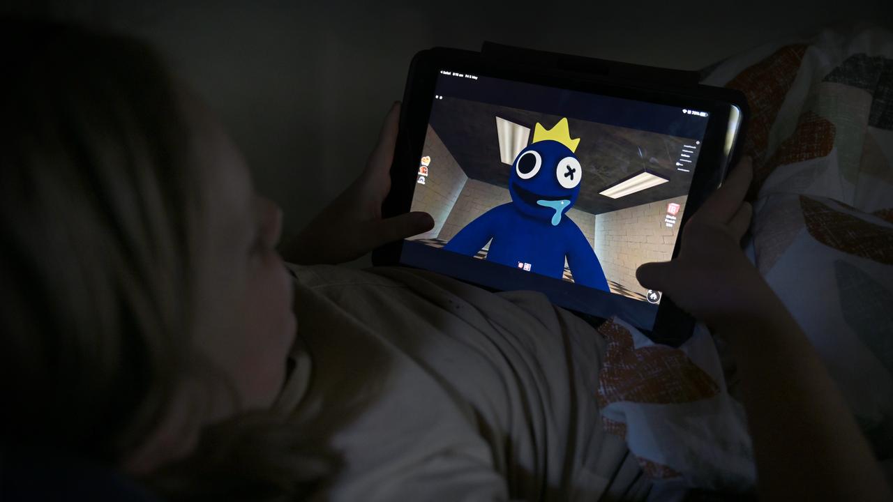 A young child plays the Rainbow Friends Roblox game (file image)