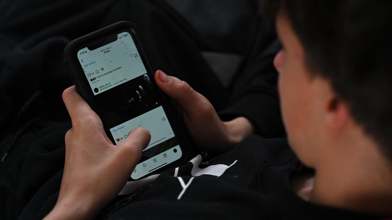 A teenager uses his phone to access social media (file image)