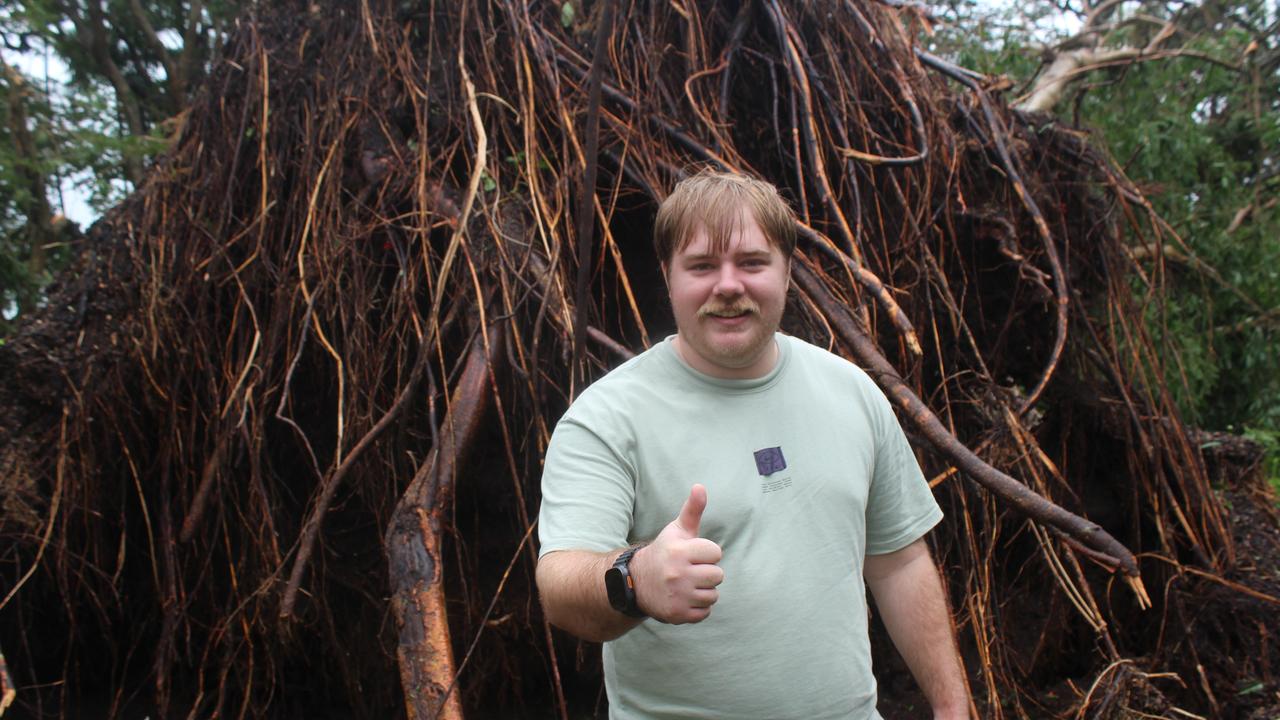 Keelan Edwards in front of a felled tree.
