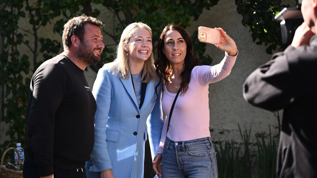 Amelia Hamer (centre) poses for a photo