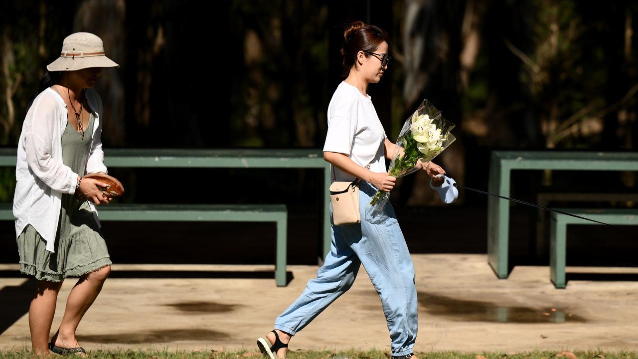 People place flowers at the scene where a teen was fatally stabbed