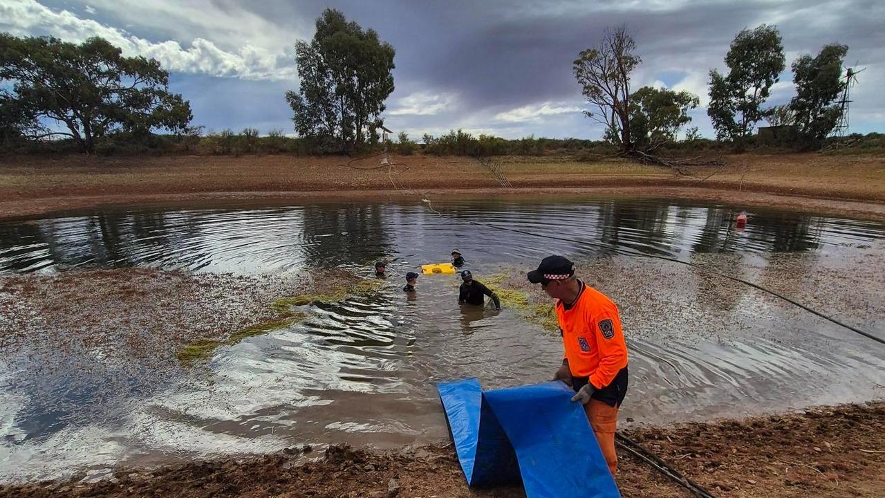 Police draining a dam
