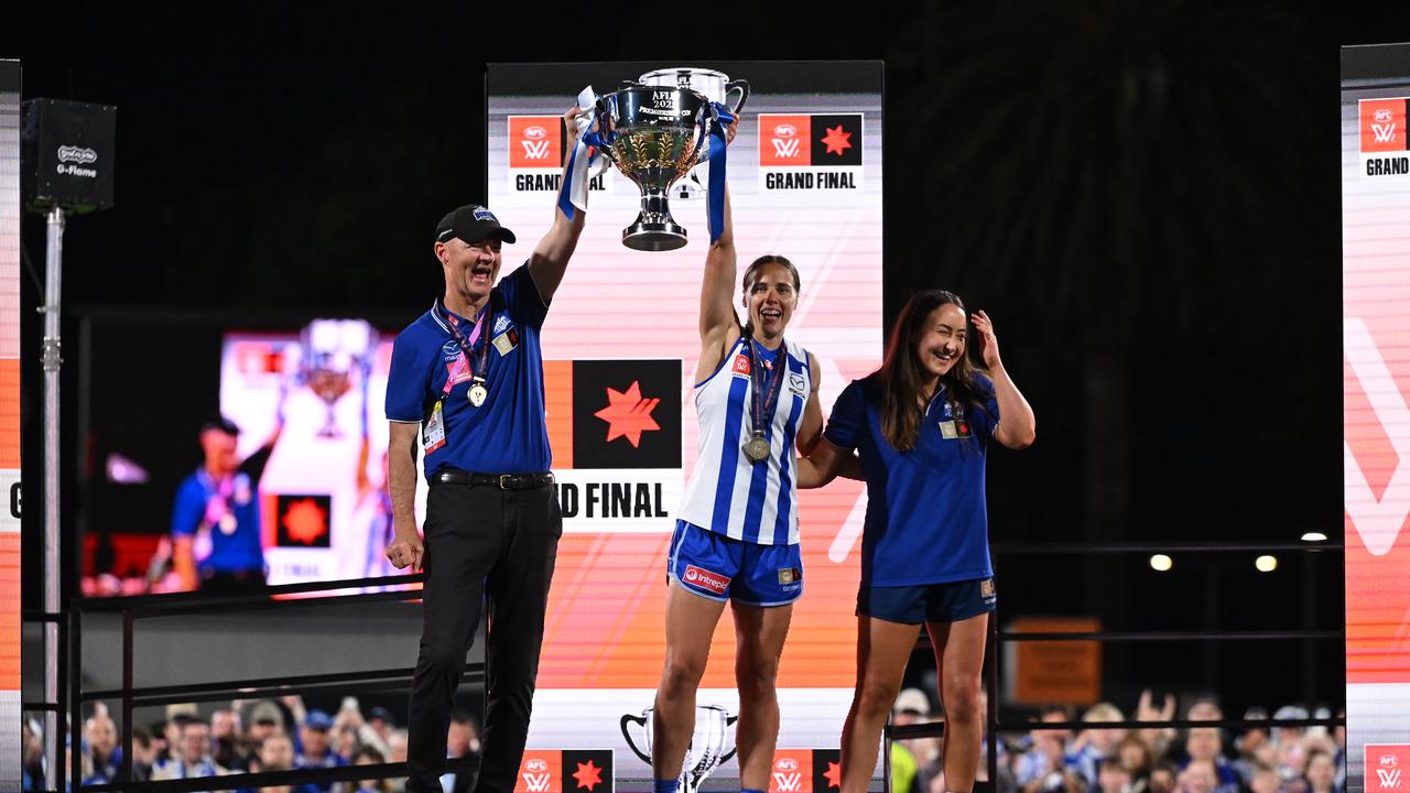 Darren Crocker and captain Jasmine Garner raise the premiership cup.