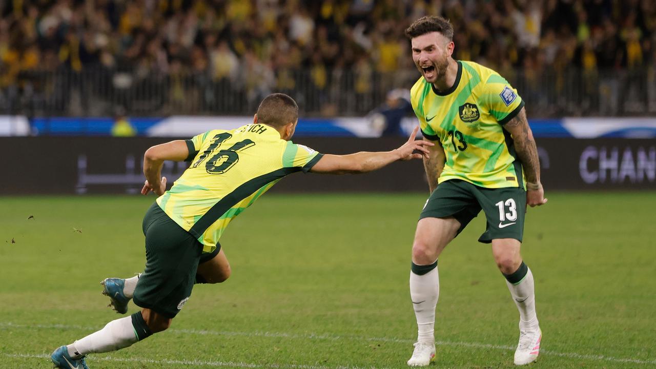 Aziz Behich celebrates a goal as Aiden O'Neill looks on