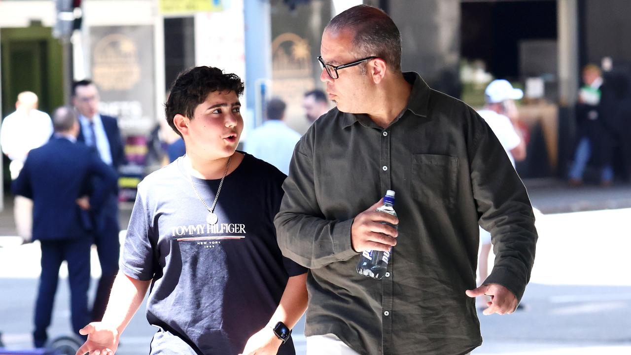 Nicholas Tadros (C) arrives with father Simon