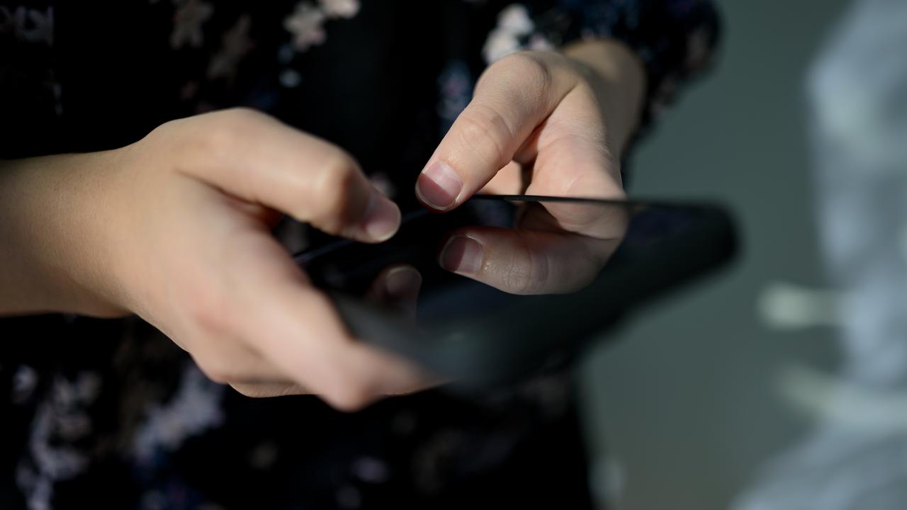 Young person holding phone