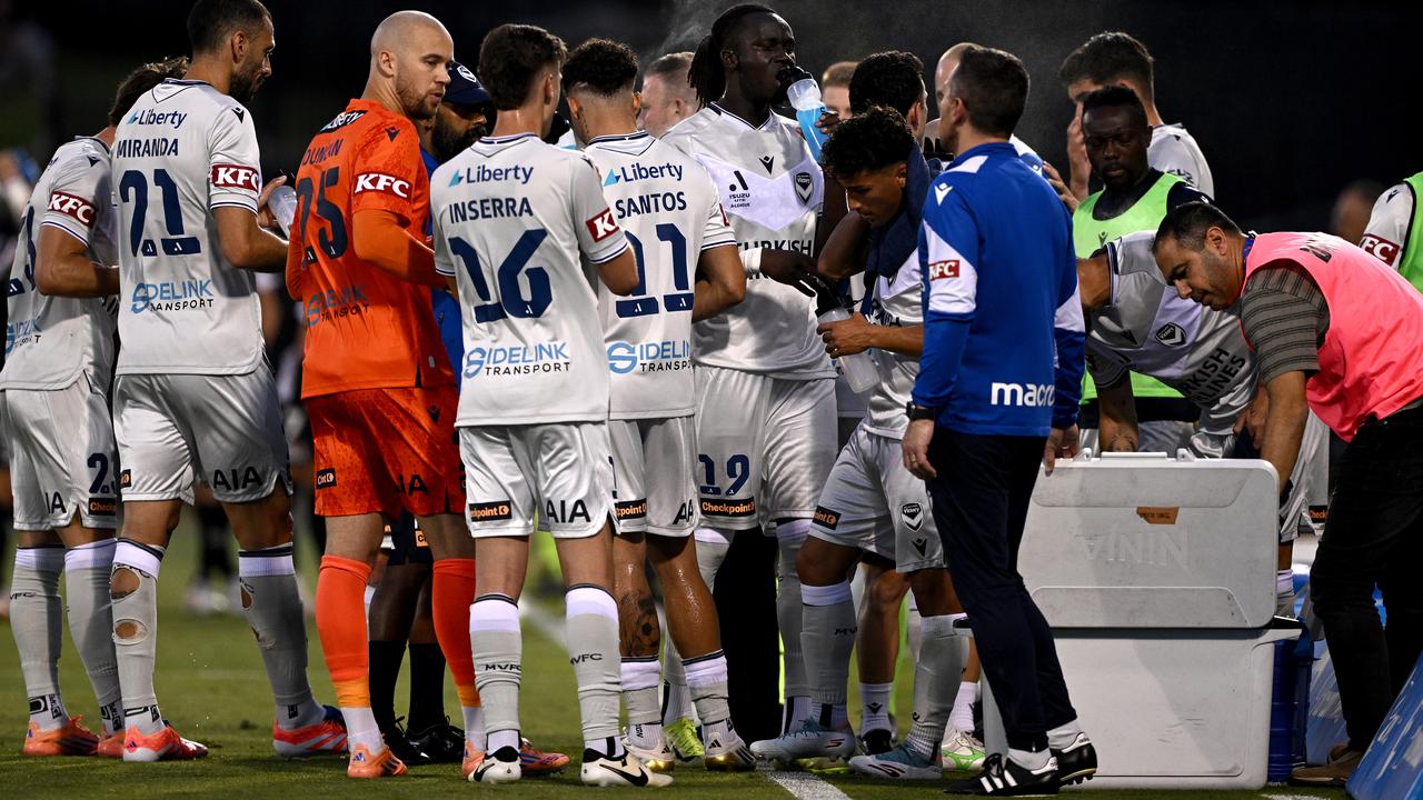 Victory players cool off on a sweltering night in Sydney.