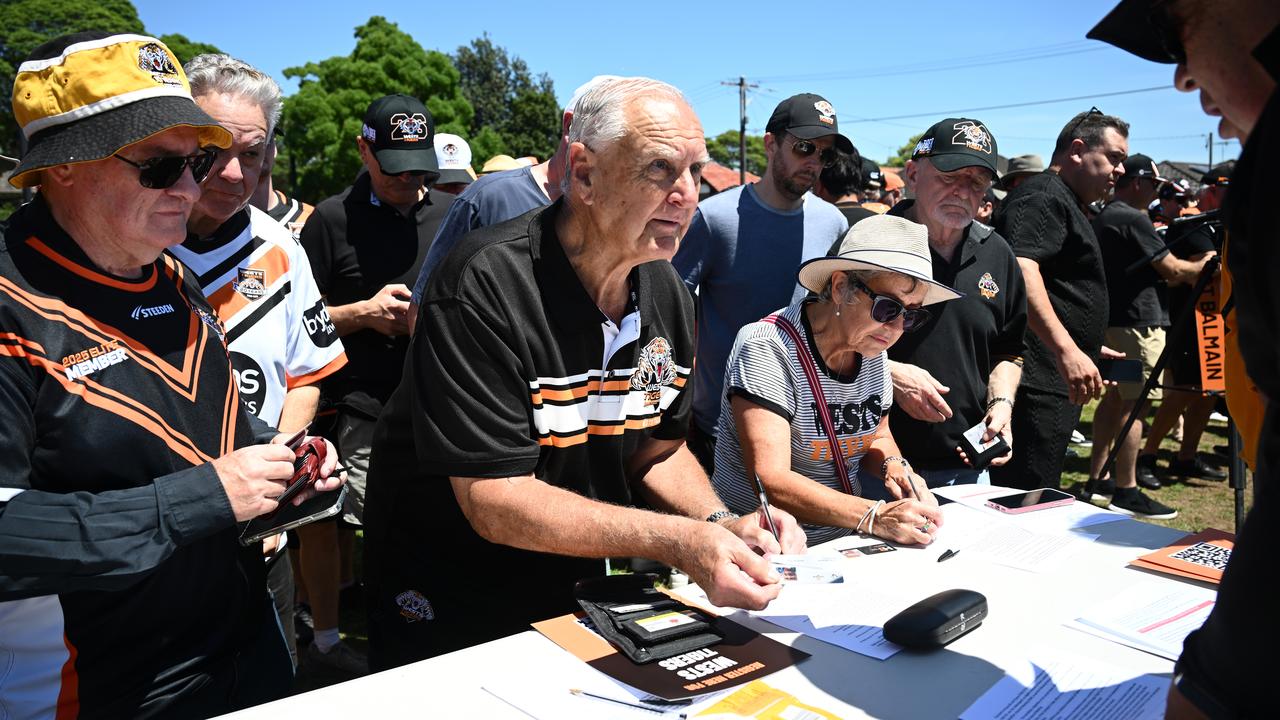Wests Tigers supporters sign a petition.