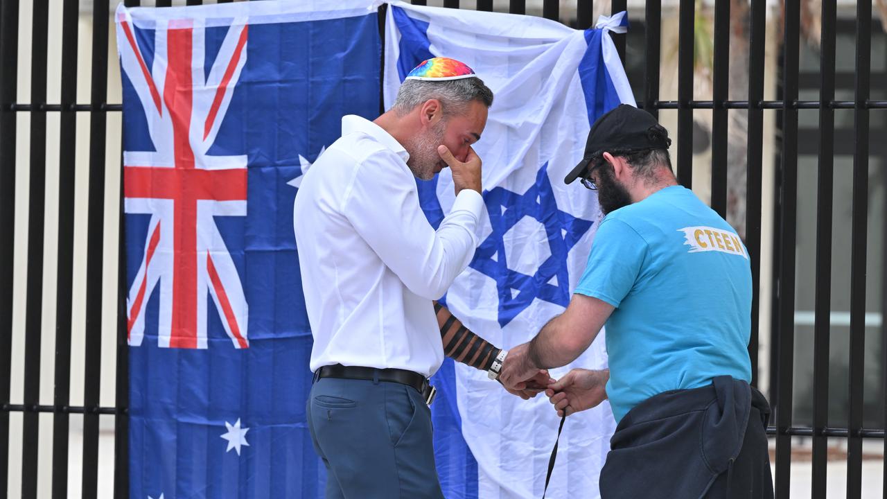 Alex Ryvchin cries at memorial