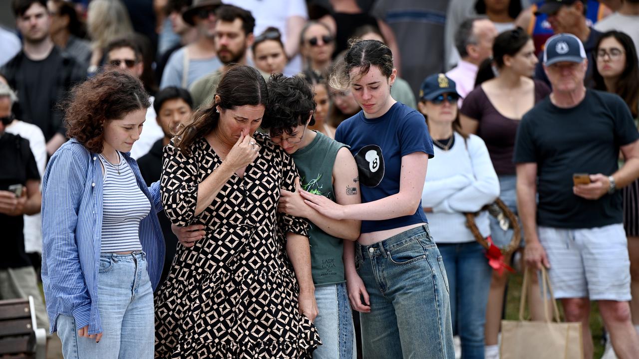 Mourners place flowers at a memorial at Bondi Beach