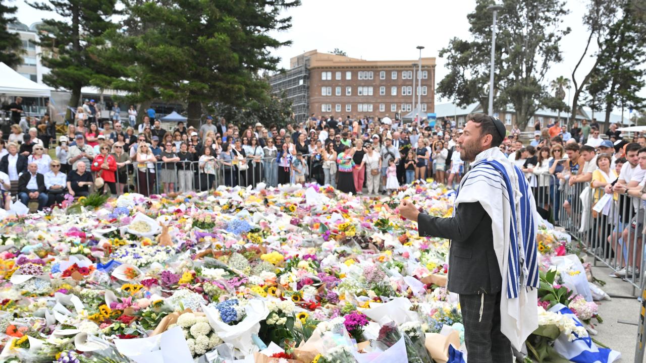 A rabbi addressing mourners at a makeshift memorial at Bondi Beach