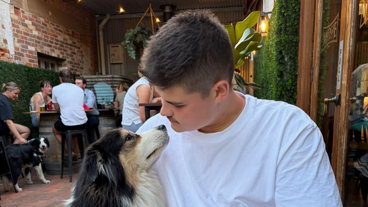 Probationary Constable Jack Hibbert poses with a dog in Sydney