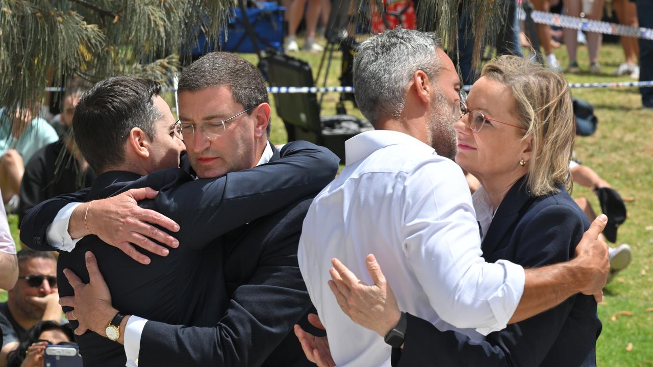 Sussan Ley hugs Alex Ryvchin at a makeshift memorial at Bondi Beach