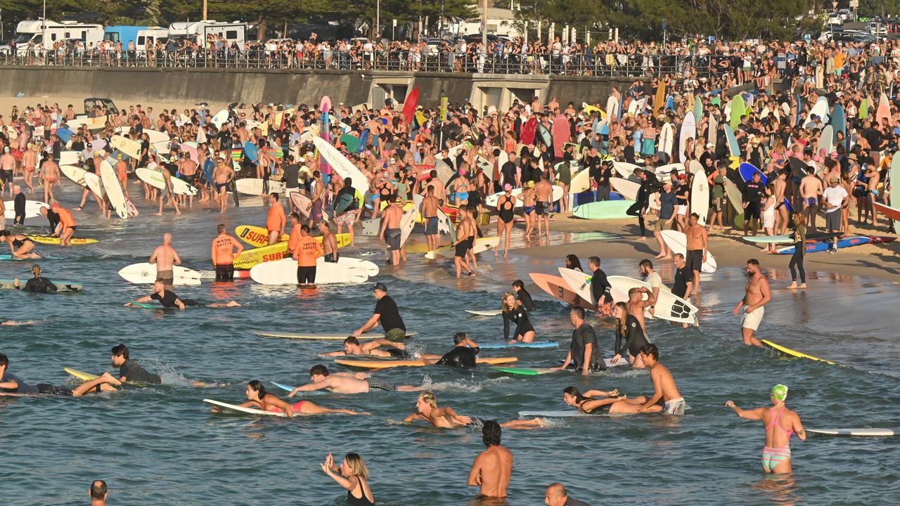 Surfers and swimmers pay tribute during a paddle out at Bondi Beach